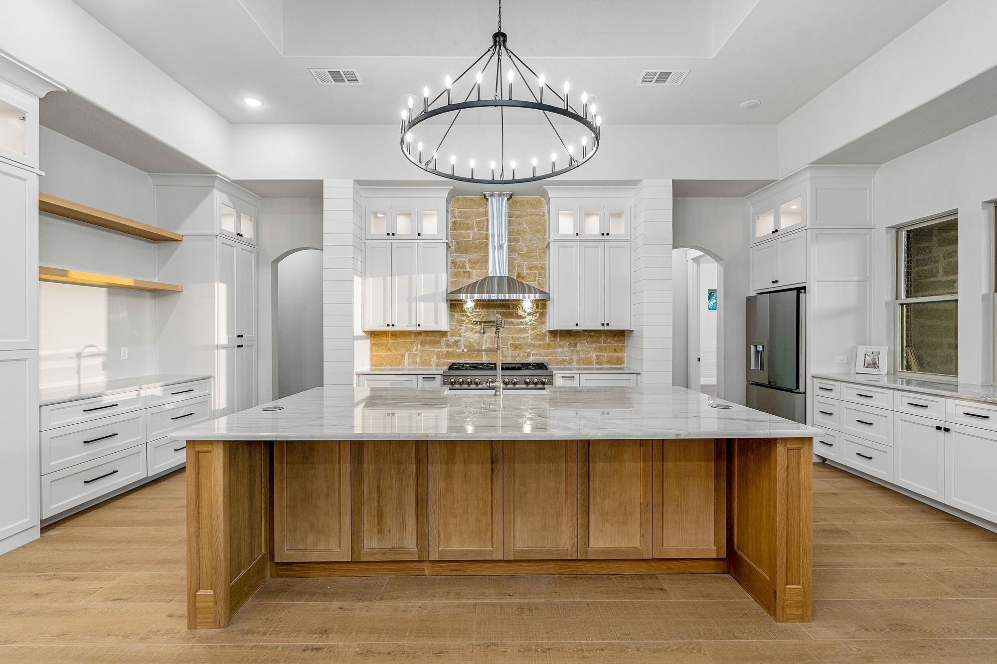 Chef's kitchen with white oak island and chandelier