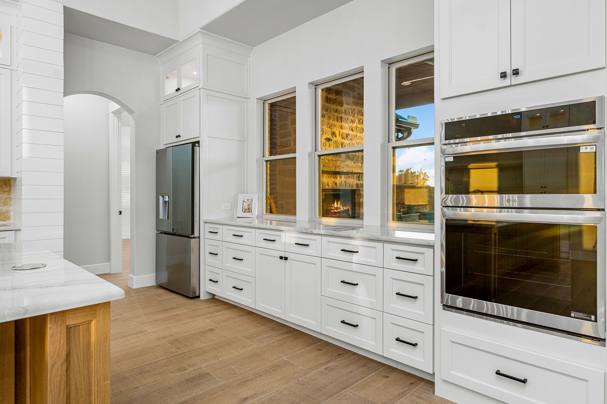 Appliance wall with double ovens and integrated fridge