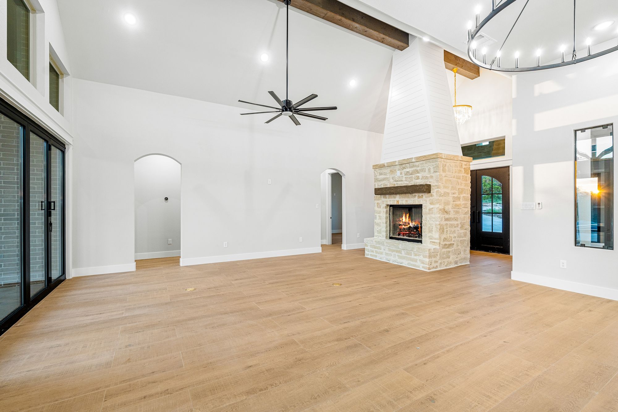 Great room with stone fireplace and custom kitchen