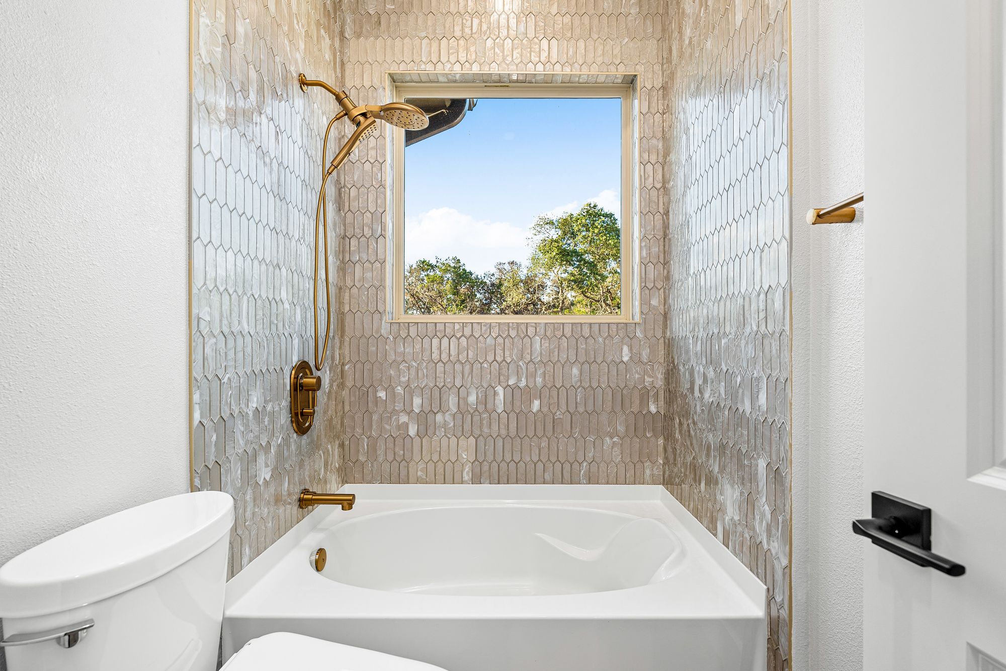 Guest bath with penny-tile surround and brass fixtures