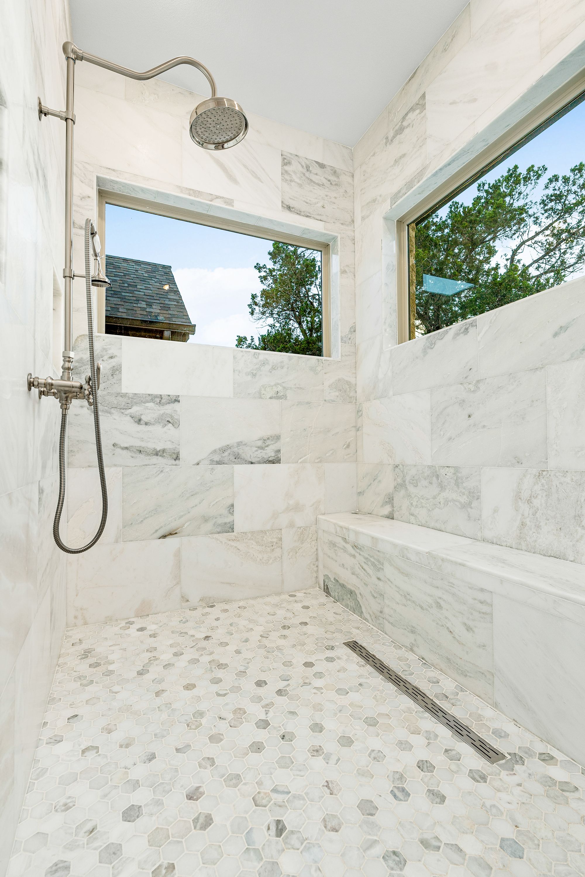Marble walk-in shower with hex-tile floor