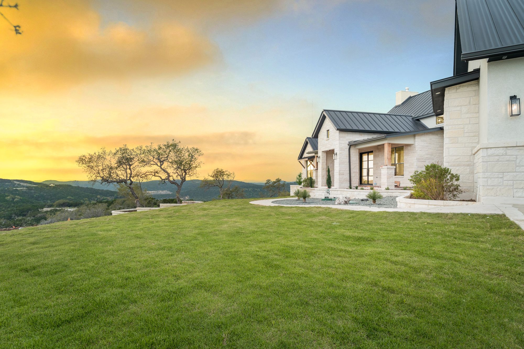 Hill Country estate exterior at sunset