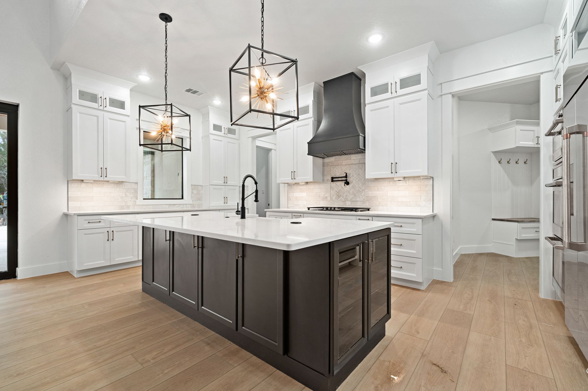 Kitchen with sculptural black hood centered