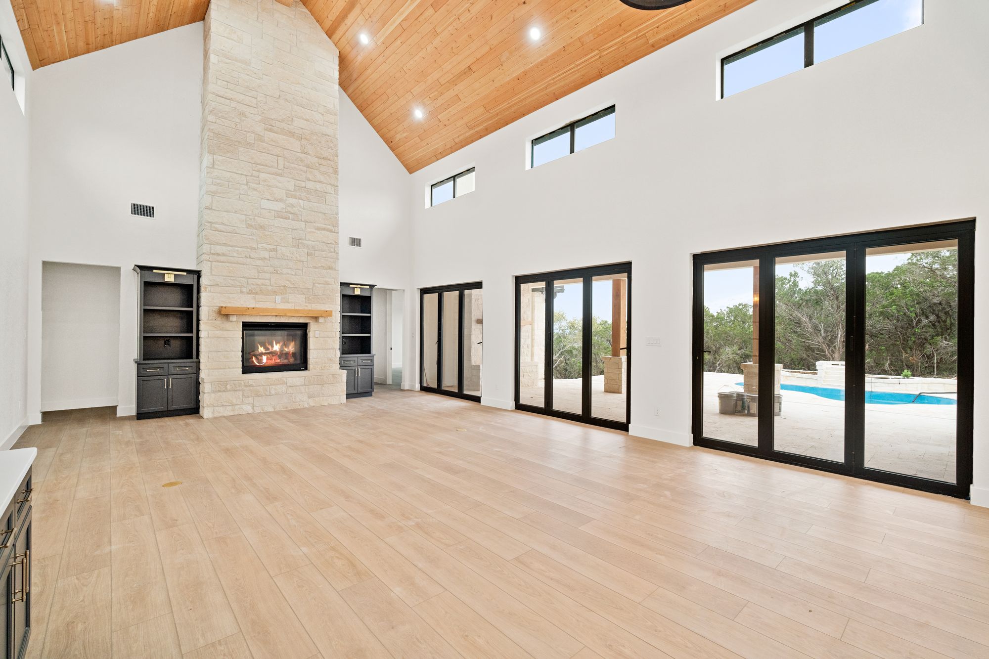 Vaulted great room with fireplace and glass wall