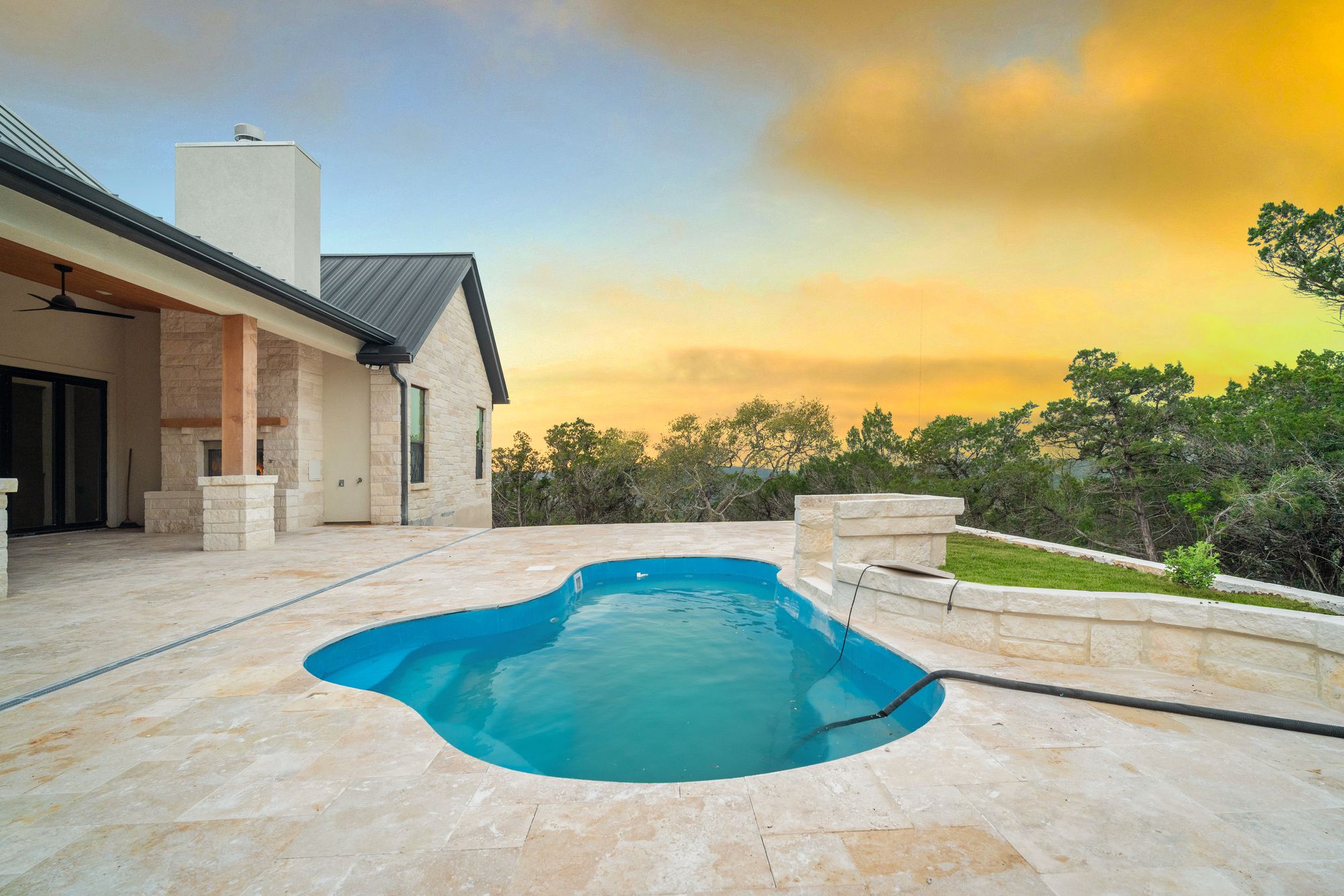 Luxury home outdoor terrace with pool at sunset